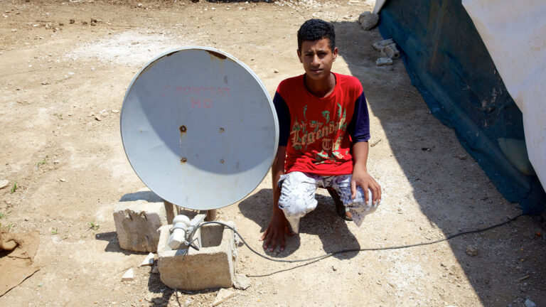 Syrian citizen next to satellite