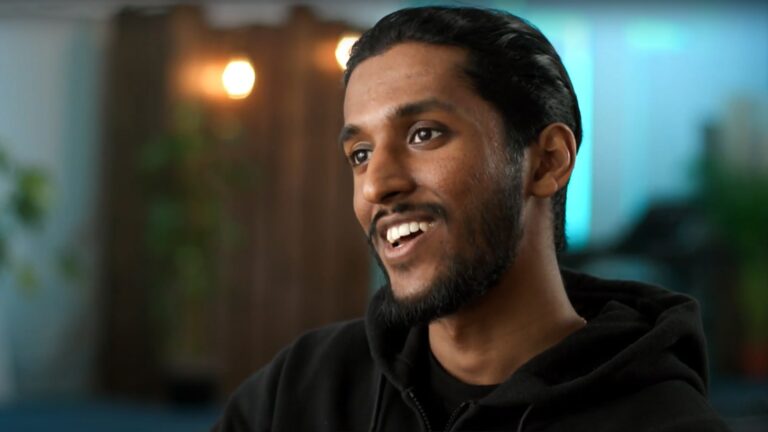 A young man smiles