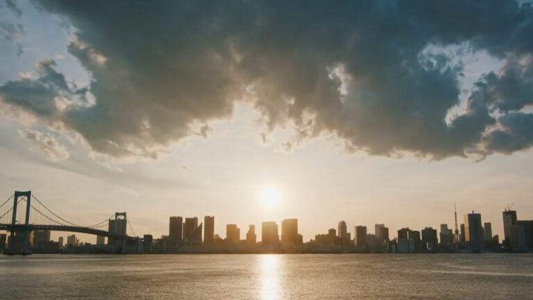 A city skyline with sun and clouds